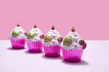 Colorful christmas baubles in form of cupcake