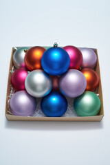 Box with christmas balls on white background