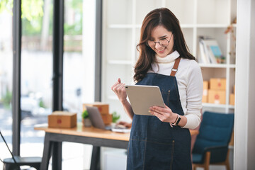 Small start-up business owners checking parcels at work, freelancers, salespeople, checking...