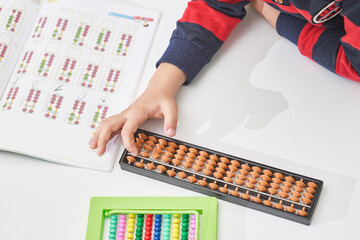 Schoolboy do mental math. Mental mathematics. 8 years old multiracial boy busy with mental...