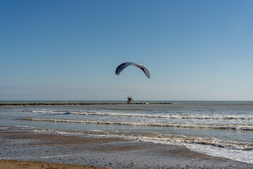 View of a paraglider crossing the beautiful Burriana beach in Spain. You need to do this sport to...