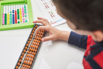 Schoolboy do mental math. Mental mathematics. 8 years old multiracial boy busy with mental...