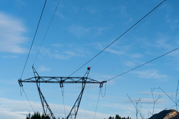 High voltage electrical tower against the blue sky.