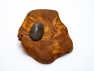 Round smooth stone inside wooden cut