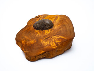 Round smooth stone inside wooden cut