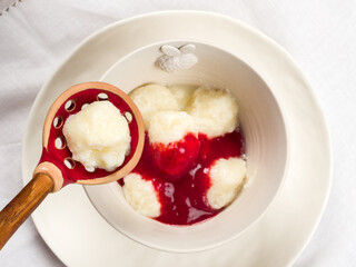 Lazy dumplings of cottage cheese with strawberry sauce
