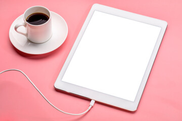 Obraz na płótnie Canvas digital tablet with blank screen on a pink background with a cup of coffee