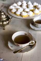 Obraz na płótnie Canvas Breakfast tea served with fine china porcelain set and homemade mini lemon pie