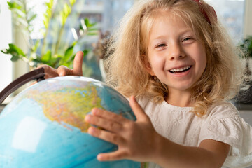 little girl with a globe, study geography, back to school