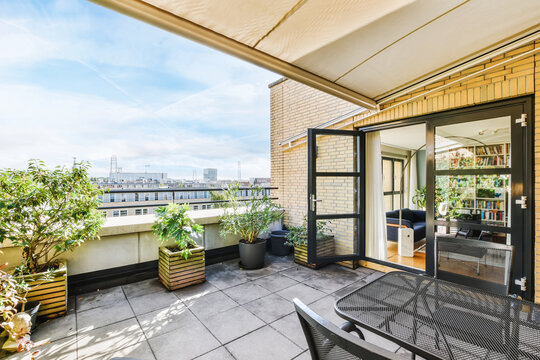 Lovely balcony with lots of potted flowers and amazing views