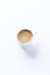 Cup of coffee on bright paper background. Copy space.