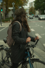 Woman with a bicycle. Beautiful girl with the bike.  Female on bicycle. Woman crossing the road.