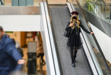 Shopping at the time of Corona Virus with green passport. Fashion woman at the walking with...