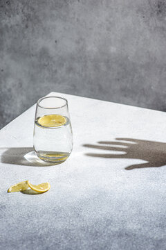 water with lemon on a gray background