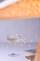 glass of wine on white background and christmas lights