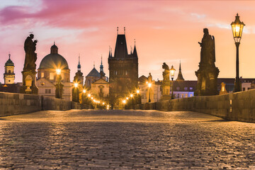 Beautiful early morning dawn twilight at the famous medieval Charles Bridge that crosses the Vltava river. Prague or Praha, Czech republic.