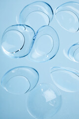 contact lenses on blue background close up view   - Image