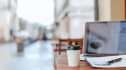 close up. background image of a table with a laptop on the cafe terrace.