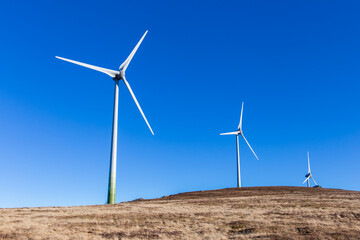 Windpark at the Handalm mountain range in Styria, Austria in autumn with blue clear skies