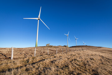 Windpark at the Handalm mountain range in Styria, Austria in autumn with blue clear skies	
