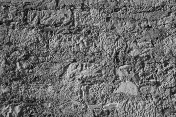 Brown stone wall, close up. Natural design with pattern of rectangular blocks and lines. Ancient masonry facade. Stone wall background for poster, calendar, post, wallpaper, card, banner, cover