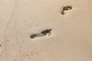 footprints of two human feet in the sand