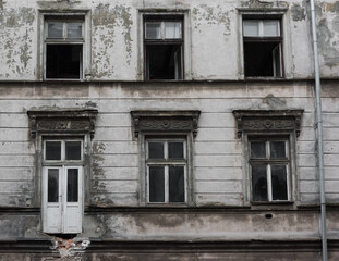 Fototapeta na wymiar Five windows and an old door of a house