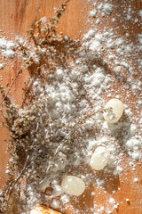 festive christmas background with plants, lollipops and powdered sugar on a natural surface, top view,.