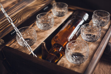 Wine glasses for strong alcohol. Shops and a bottle of alcohol in the minibar. Home bar