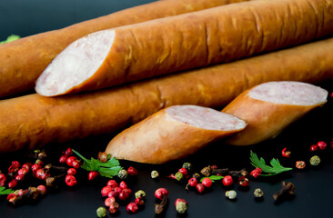 Tasty sausages and vegetables isolated over solid background