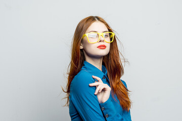 Fototapeta premium woman in blue shirt yellow glasses posing fashion