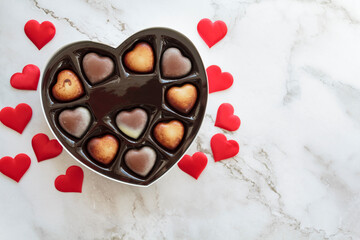 Heart Box of Valentines Chocolates and red hearts. Top view with copy space