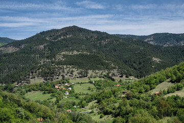 The natural landscape, the beauty and majesty of green meadows and forests. Top view. Rural house in field. Beautiful landscape photography of nature