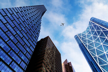 Skyscraper Downtown Office Buildings in Calgary, Alberta, With Plane Flying Overhead