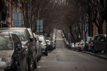 Selective blur on lines of cars parked in the city center of Belgrade, Serbia, on a residential street where vehicles are permitted to use parking. ..