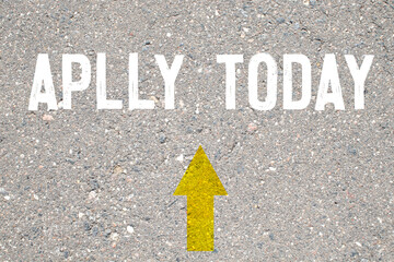 Red alarm clock and APPLY TODAY inscription written on natural sandy beach background. Time concept