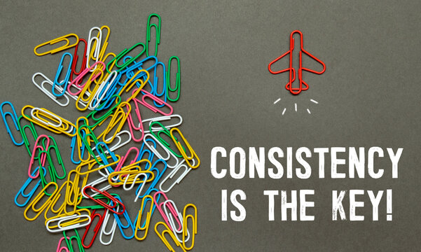 CONSISTENCY IS THE KEY, text on white paper on gray background