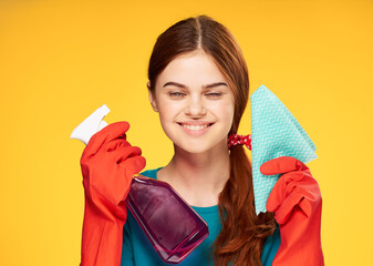 woman in rubber gloves detergent cleaning housework yellow background