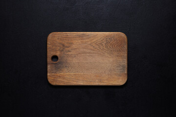 Old cutting board on a black background.