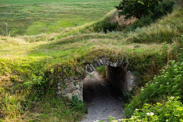 The inscription of the city of Khotyn on the background of a green field near the castle. Translation: Khotin