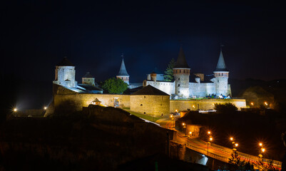 Fototapeta na wymiar View of the medieval castle in Kam'yanets'-Podil's'kyi at night