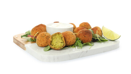 Delicious falafel balls with herbs, lime and sauce on white background