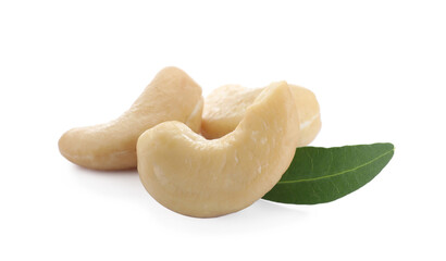 Tasty organic cashew nuts and green leaf isolated on white, closeup