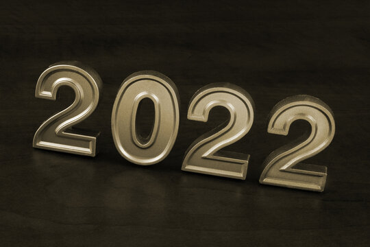 Numbers 2022 on wooden table close up as symbol of 2022 year.