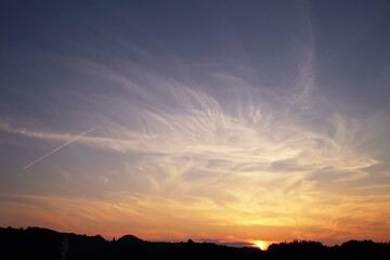 Japanese sunset (magic hour) with trails that planes make