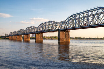 Railway bridge across the river in the evening
