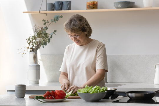 Happy Older Lady Cutting Vegetables, Natural Ingredients For Salad In Home Kitchen, Enjoying Cooking Hobby, Preparing Tasty Organic Meals, Keeping Healthy, Caring Of Clean Nutrition, Vitamins