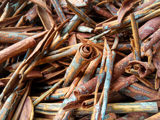 Cinnamomum cassia. Heap of dried and crushed cinnamon sticks, with left-over outer bark, or unfinished shaving.