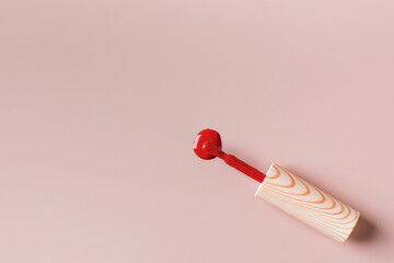 Red brush from nail polish on a light pink background. Copy space. Banner