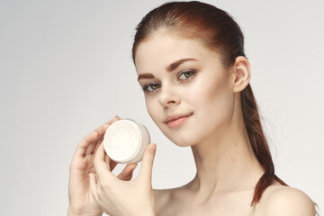 woman with jar of cream makeup face skin care close-up